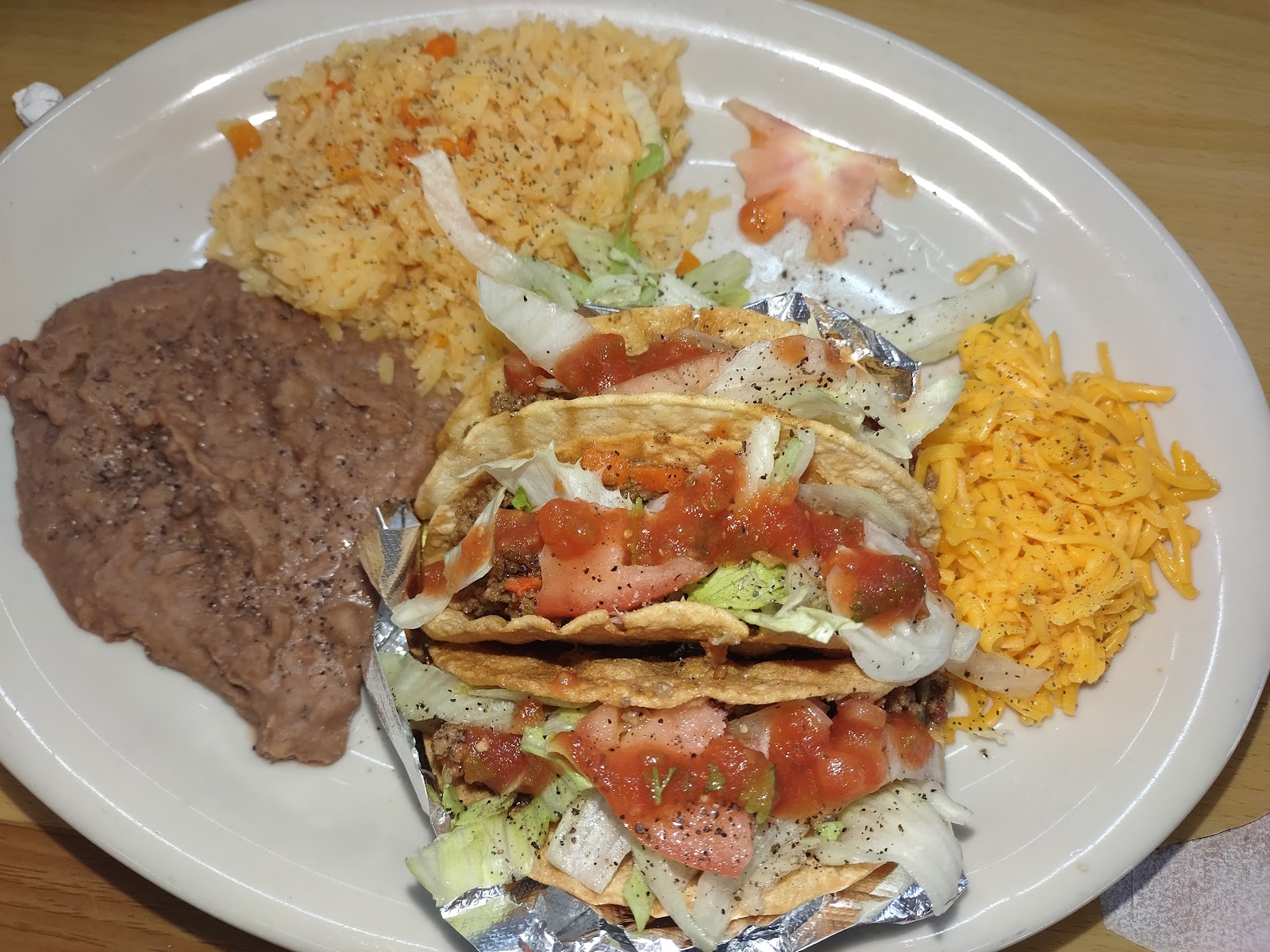 Mini beef tacos plate with rice, beans and shredded cheese