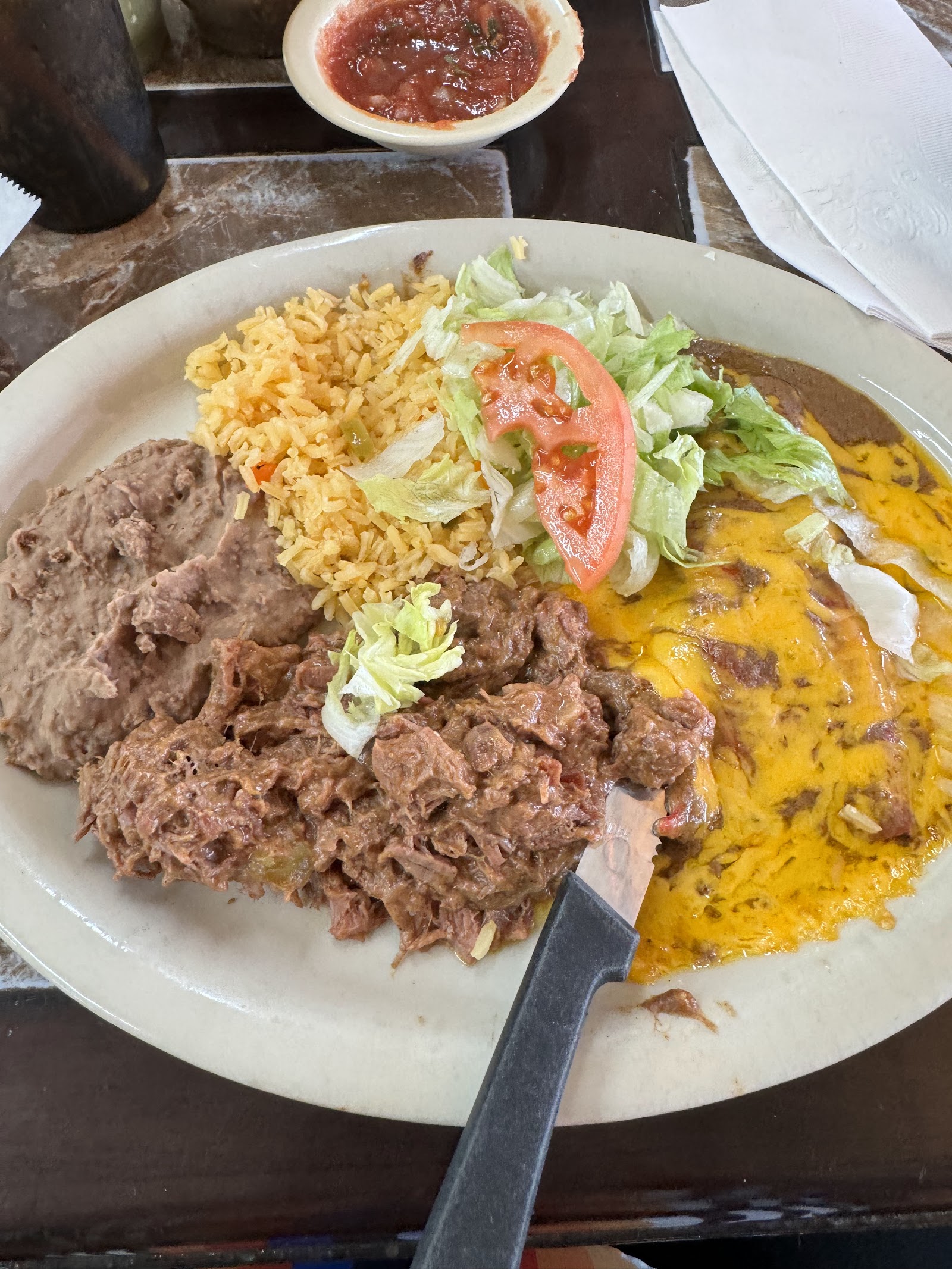 Combo plate with shredded beef, cheese enchilada, rice and beans
